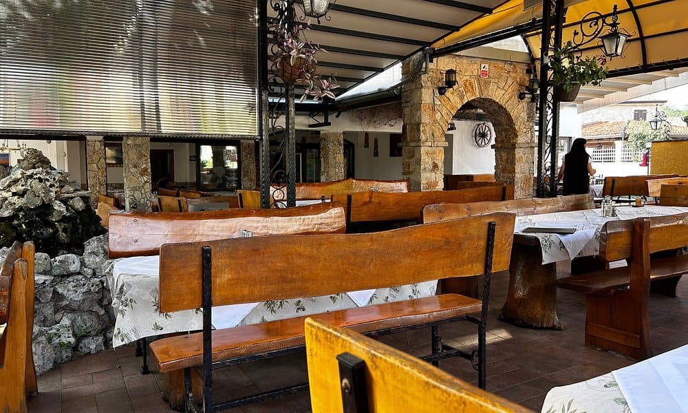 The covered terrace with wooden benches